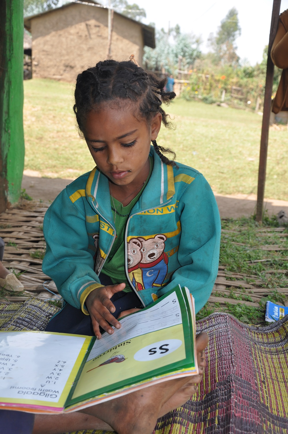 Giduma's 8-year-old sister is learning to read as well