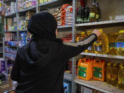 Samah*, mother of five, shops in a market for groceries after receiving cash assistance from World Vision's Syria Response. Samah's* family was one more than 4,000 who received assistance for basic necessities. | © World Vision