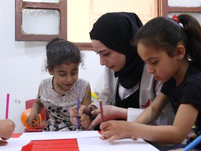 Zahra takes part in a drawing session with her facilitator at the Child Protection Centre in Ras Al-Ain. World Vision Syria Response partner, Action For Humanity