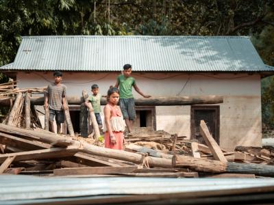 Geeta stands on the rubble of her former home after intense rains caused the Koshi River to overflow in Nepal.