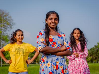 Three girls in Sri Lanka stand strongly together while looking at the camera