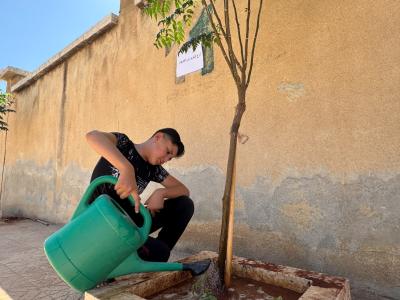 Youssef's Watering the plants he planted in his schools