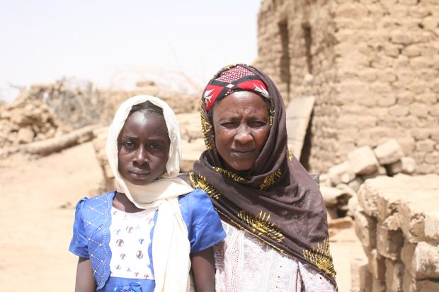 Nana with her grandmother in the compound of their home. Nana with her grandmother in the compound of their home.