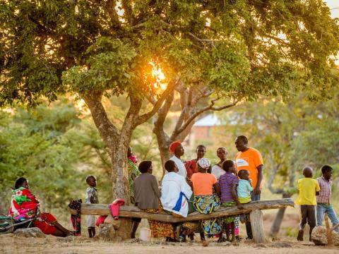 A World Vision staff member meets with the community