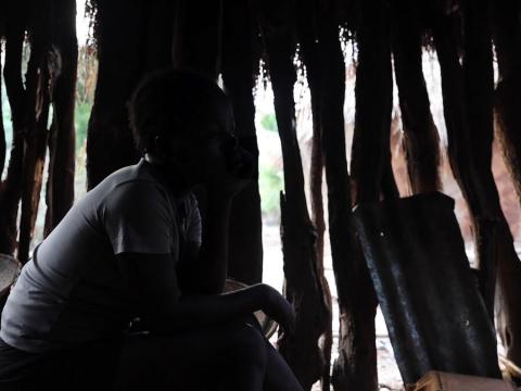15 year old girl sits in her hut in Angola, Climate change has forced her to prostitue her body to survive