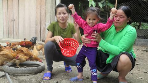 A family stands in their farm in Viet Nam