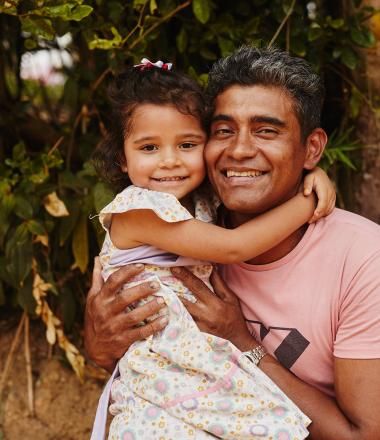 A father holds his daughter in rural Colombia