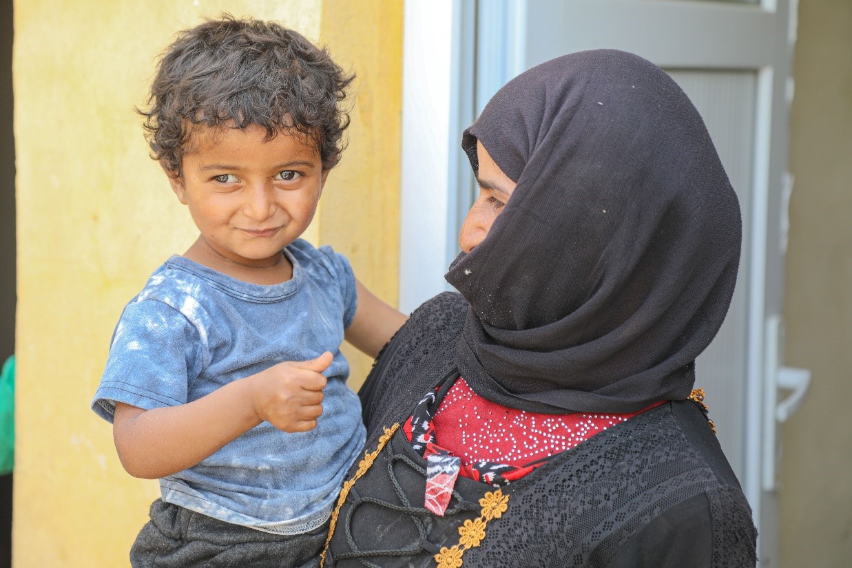 Tamer being held by his mother.  Physicians Across Continents, World Vision Syria Response Partner