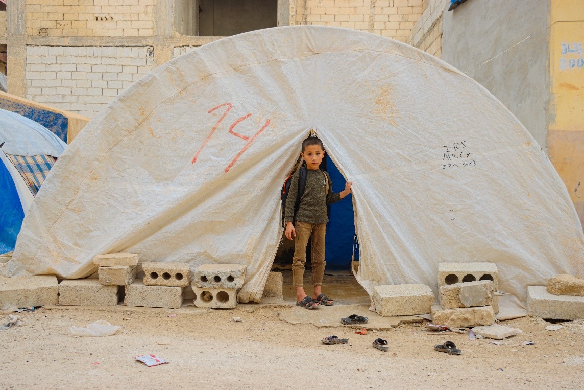 Figure 2: Badr standing next to his old tent