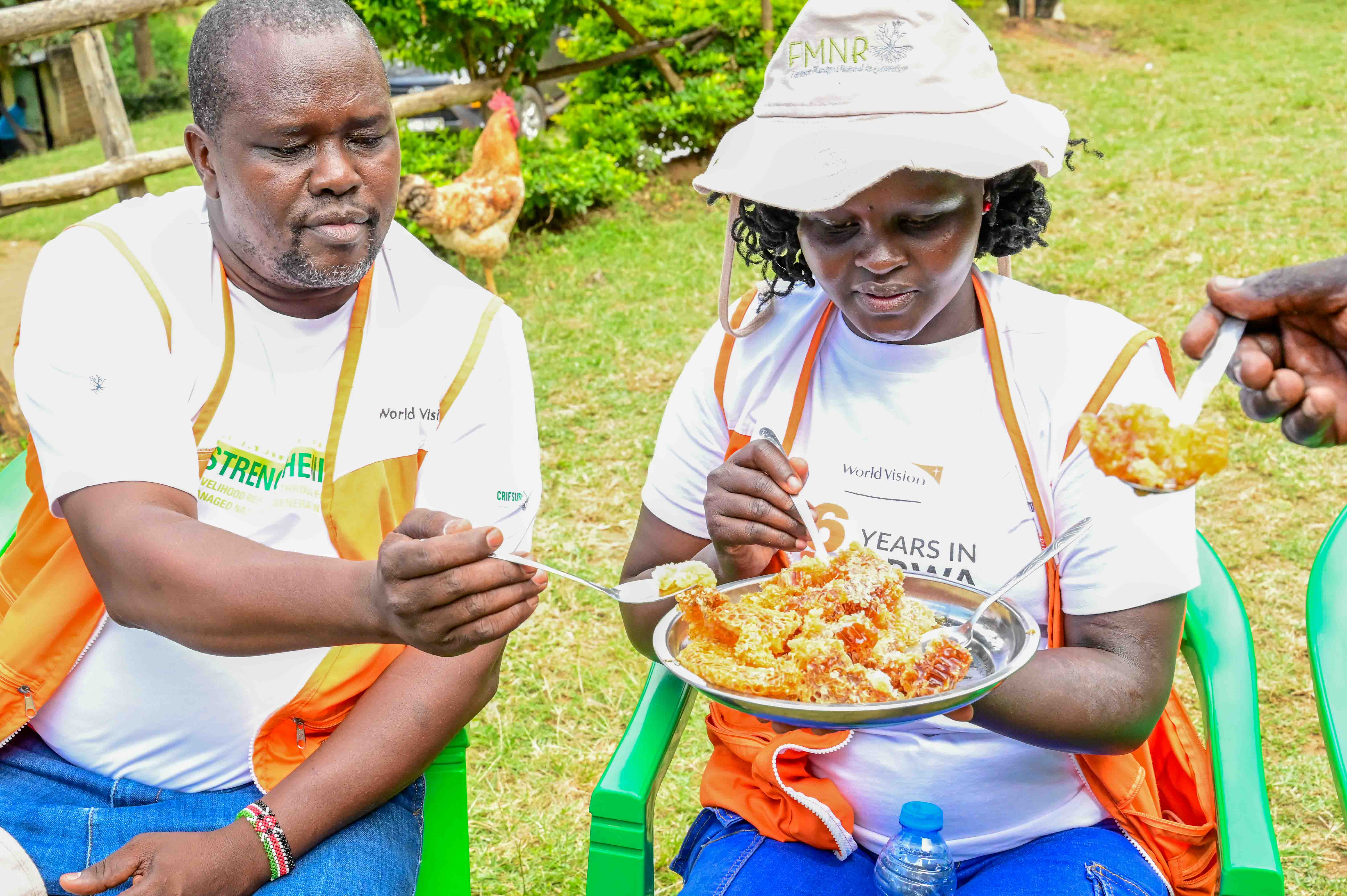 World Vision staff having a taste of honey harvested by Richard from a lead farmer’s apiary in West Pokot County. ©World Vision Photo/ Hellen Owuor