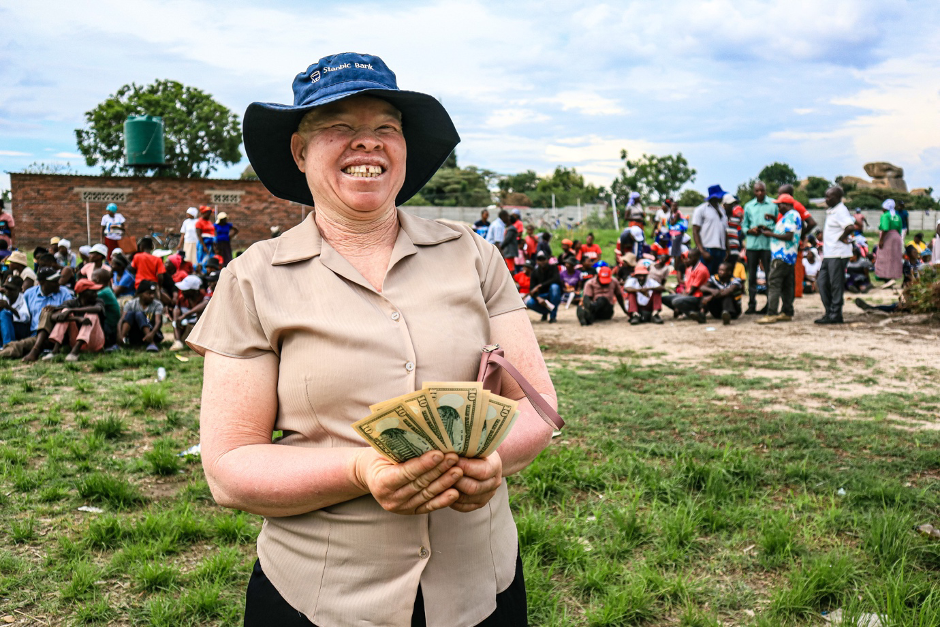 Abigail smiles for a picture during cash distributions in Epworth