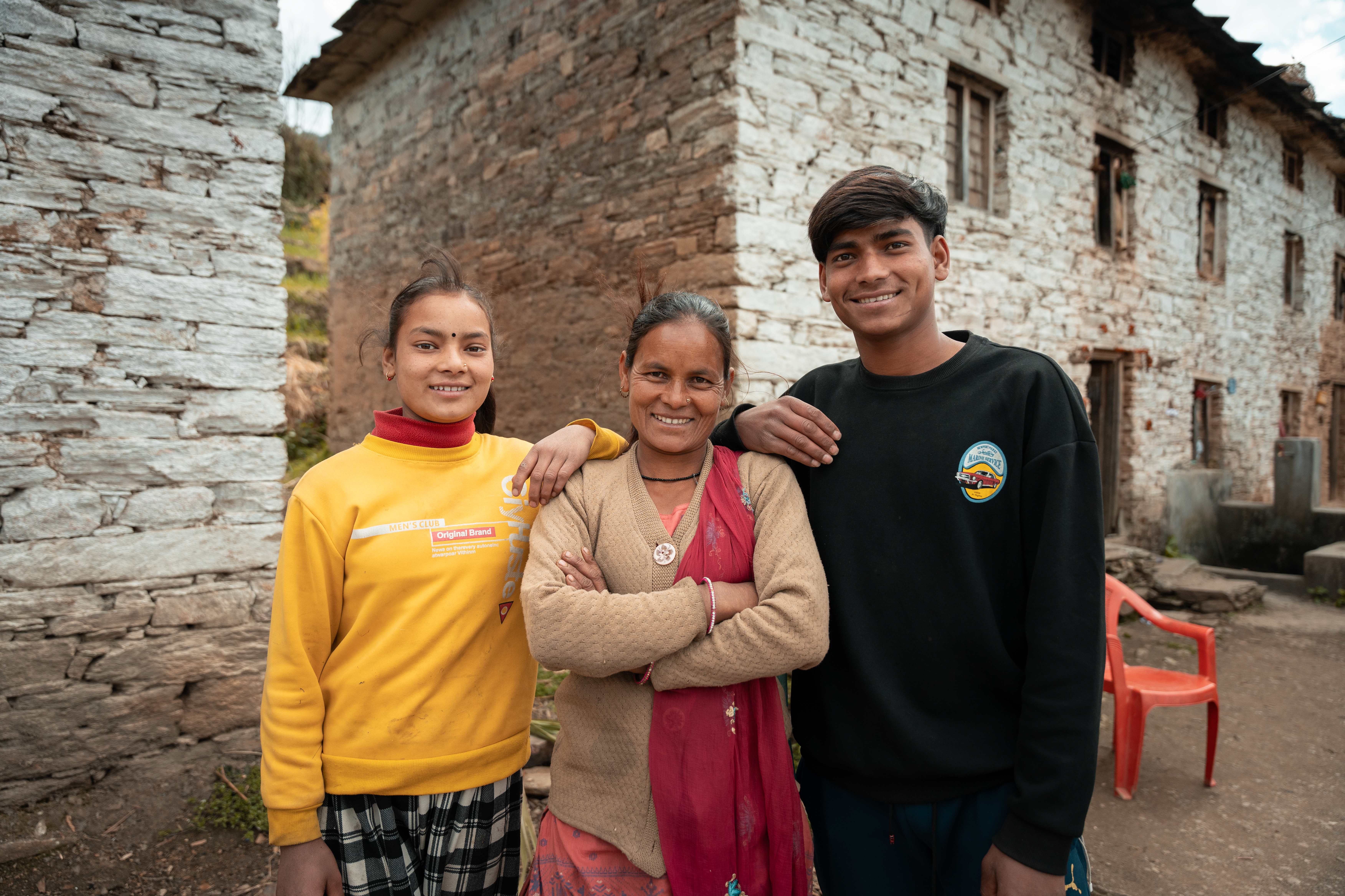 Amrita stands in front of her house