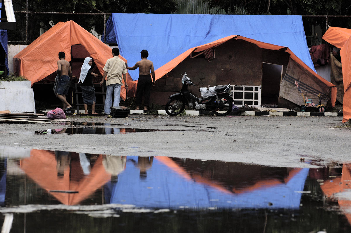 Displaced people outside makeshift tents in Indonesia