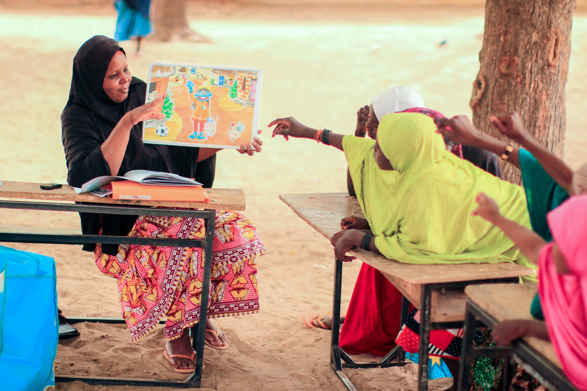 Girls learning about WASH using Sesame Workshop material