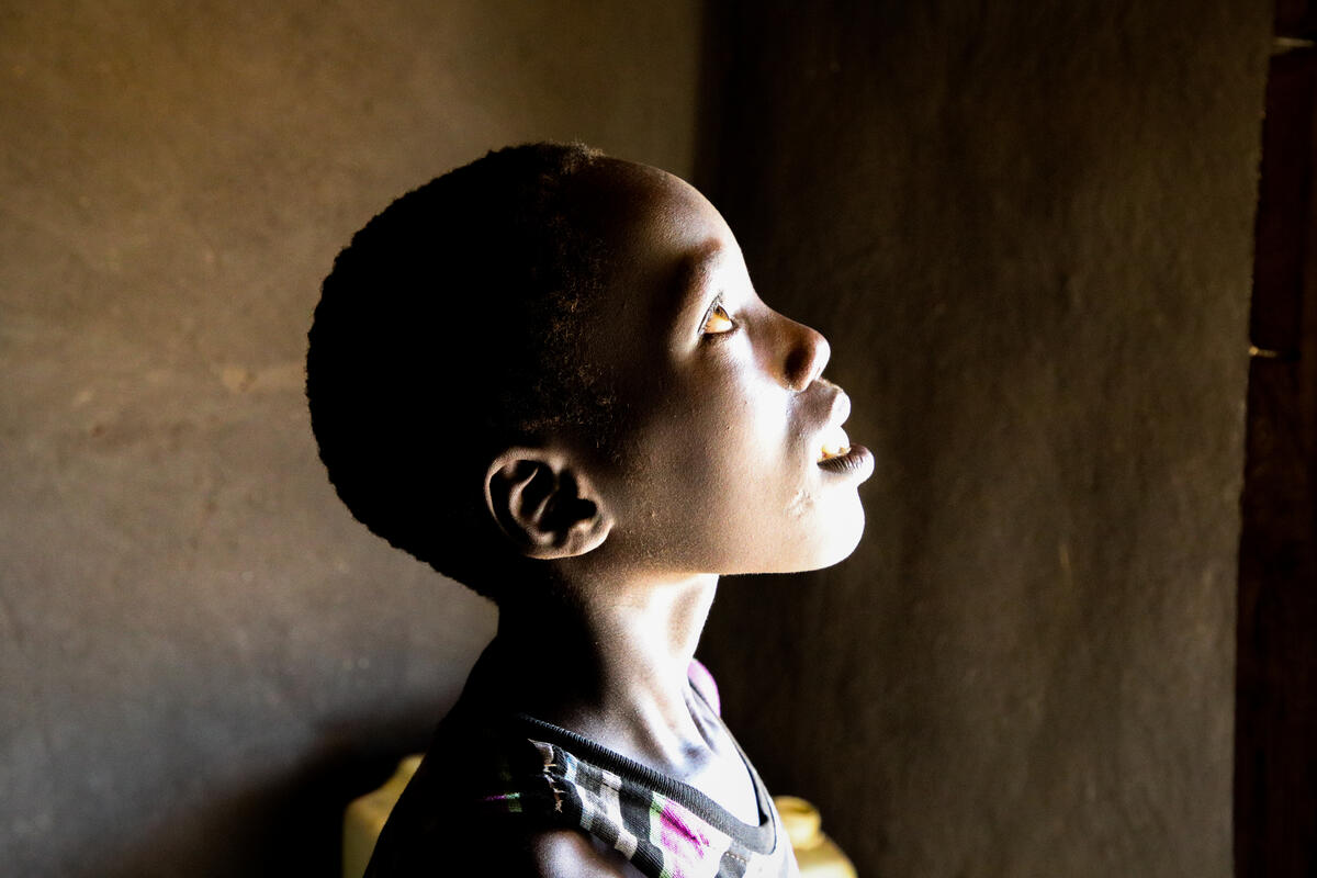 A refugee looks into the air