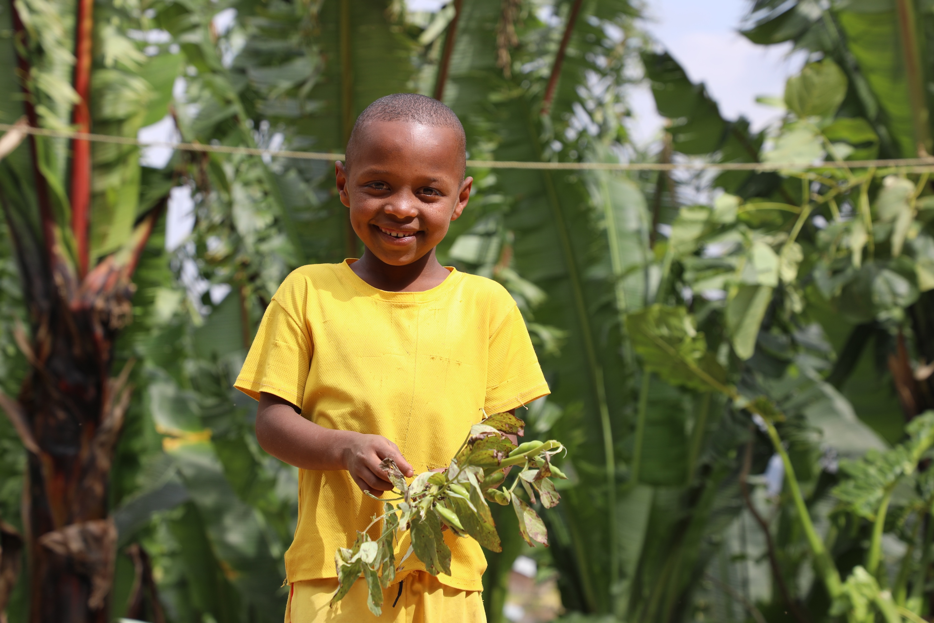 Betalo's son smiling at the garden