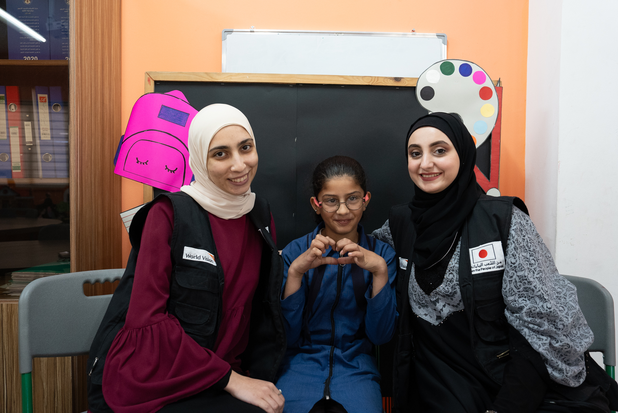 Dana happily posing with her teachers   World Vision Syria Response, Joanna Zreineh