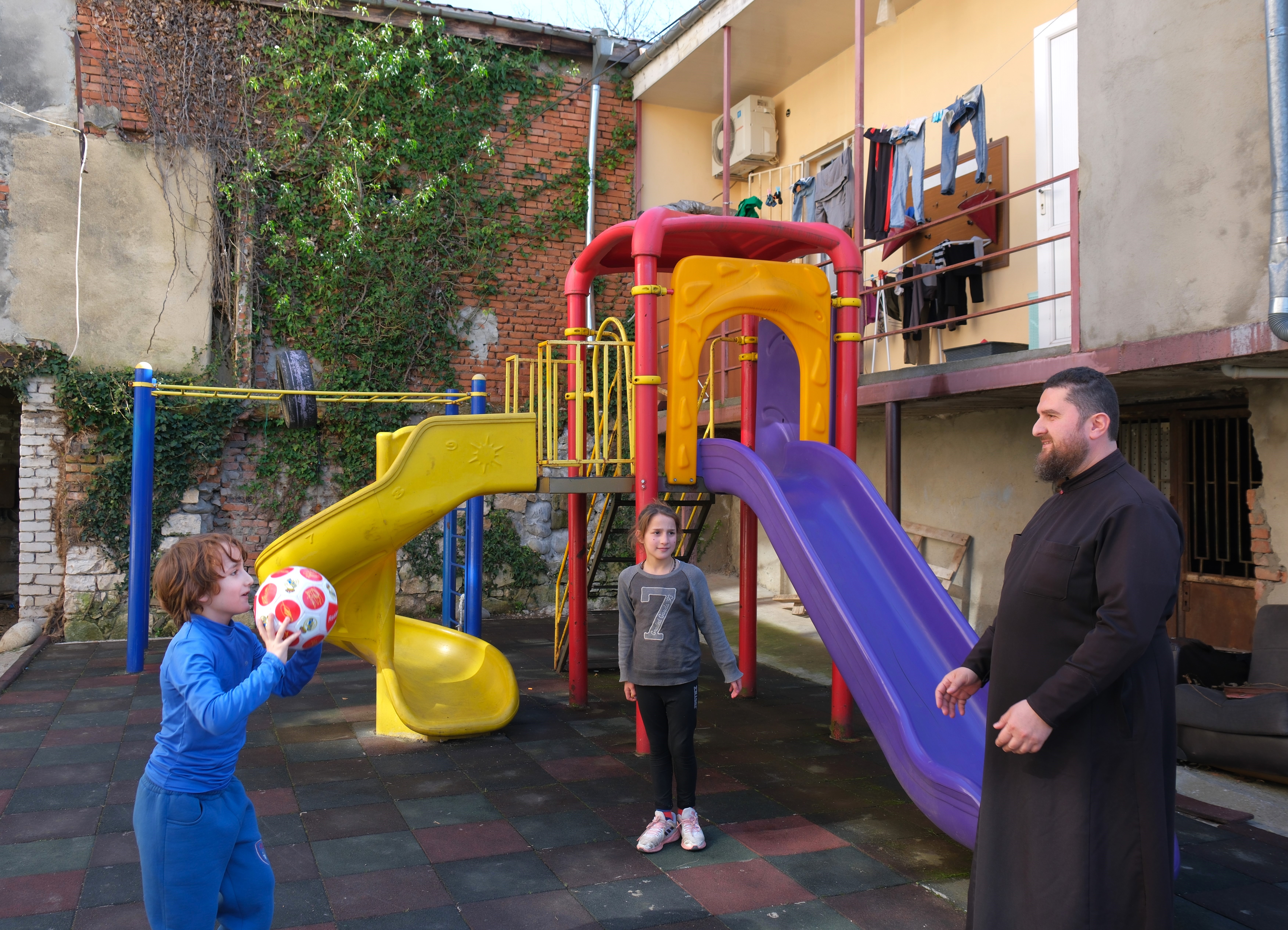 priest with children