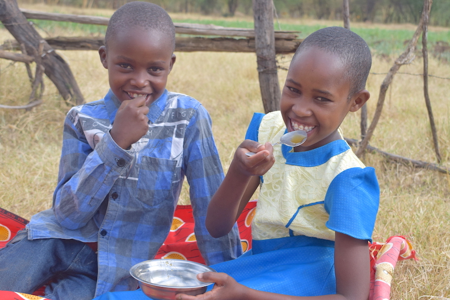 Kipkemoi (10) and her sister Chematian (8) enjoy honey harvested from their family’s beehives in Mogotio, Baringo County, Kenya. Honey is an immune booster that helps keep diseases away.