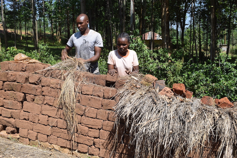 Annah with one of her employees assessing dry brick that are ready for the market at Nyamiusi, Kenya