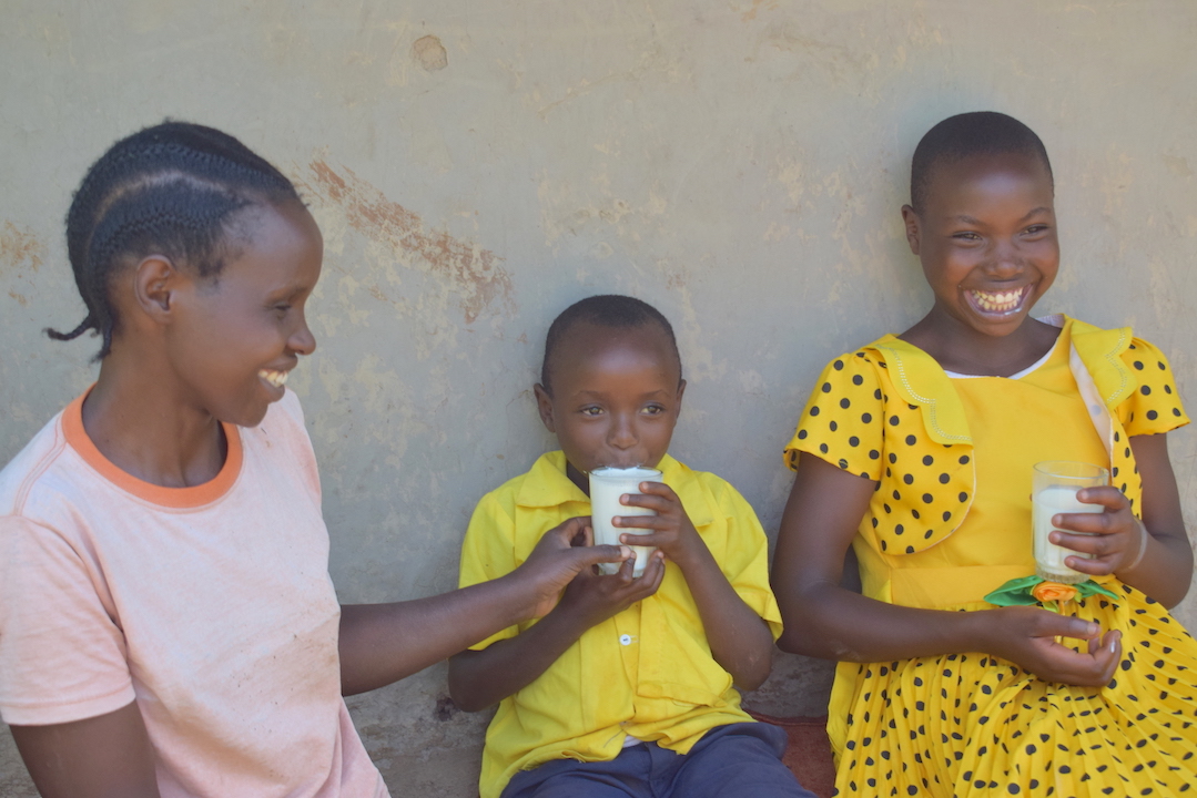 L-R: Hannah (26), Hannah Child Steven (6) and Cynthia (16) enjoying milk from cows that were bought with profit made from the family's brick making business.