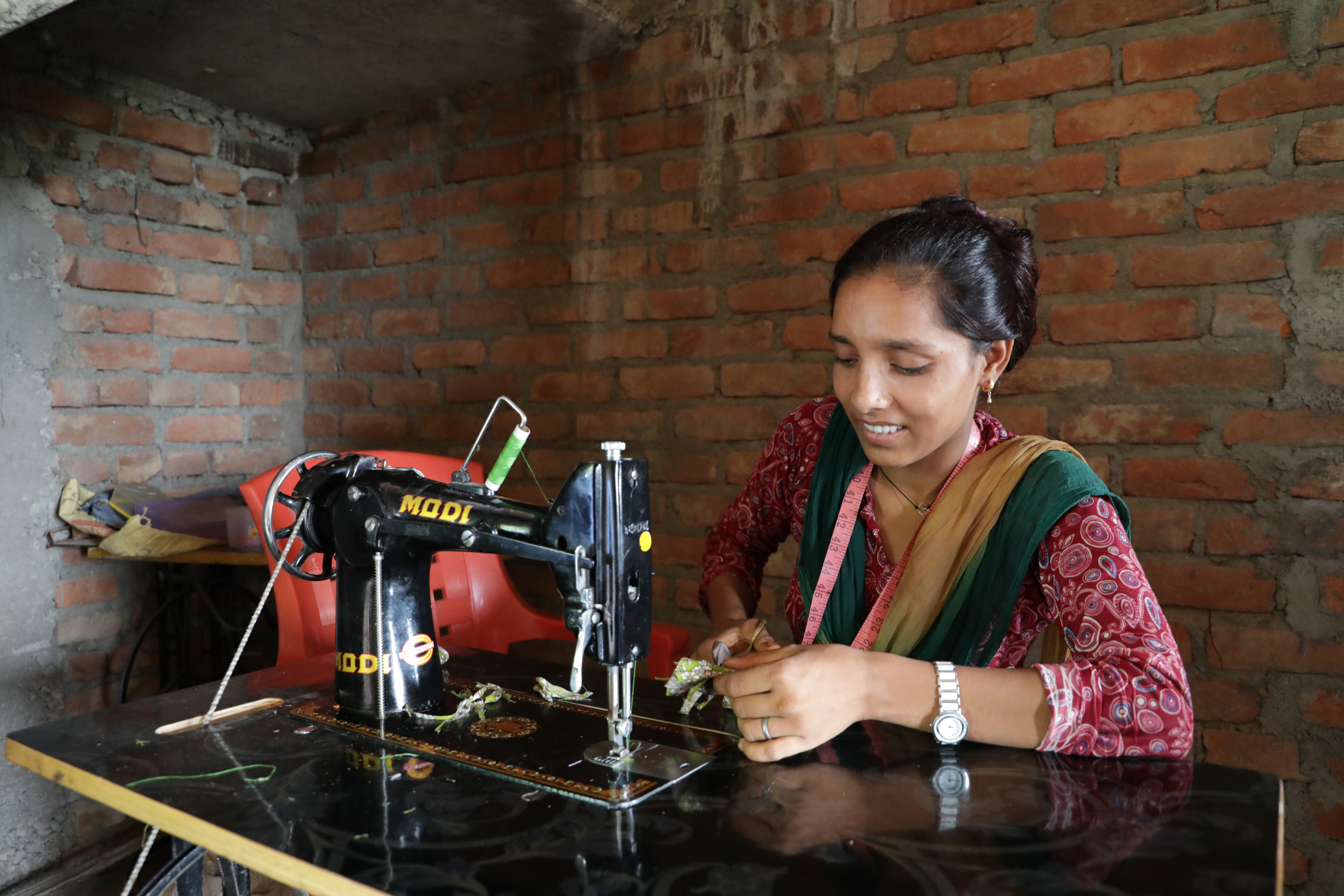 Noorjahan sews clothes