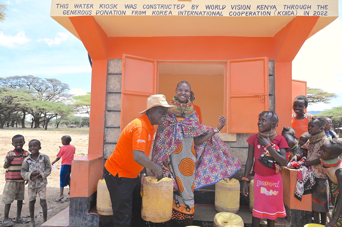 The National Director of World Vision Kenya, Gilbert Kamanga,  interacts with women and children at the Daaba Water Project implemented by World Vision in partnership with KOICA. ©World Vision Photo/Sarah Ooko.