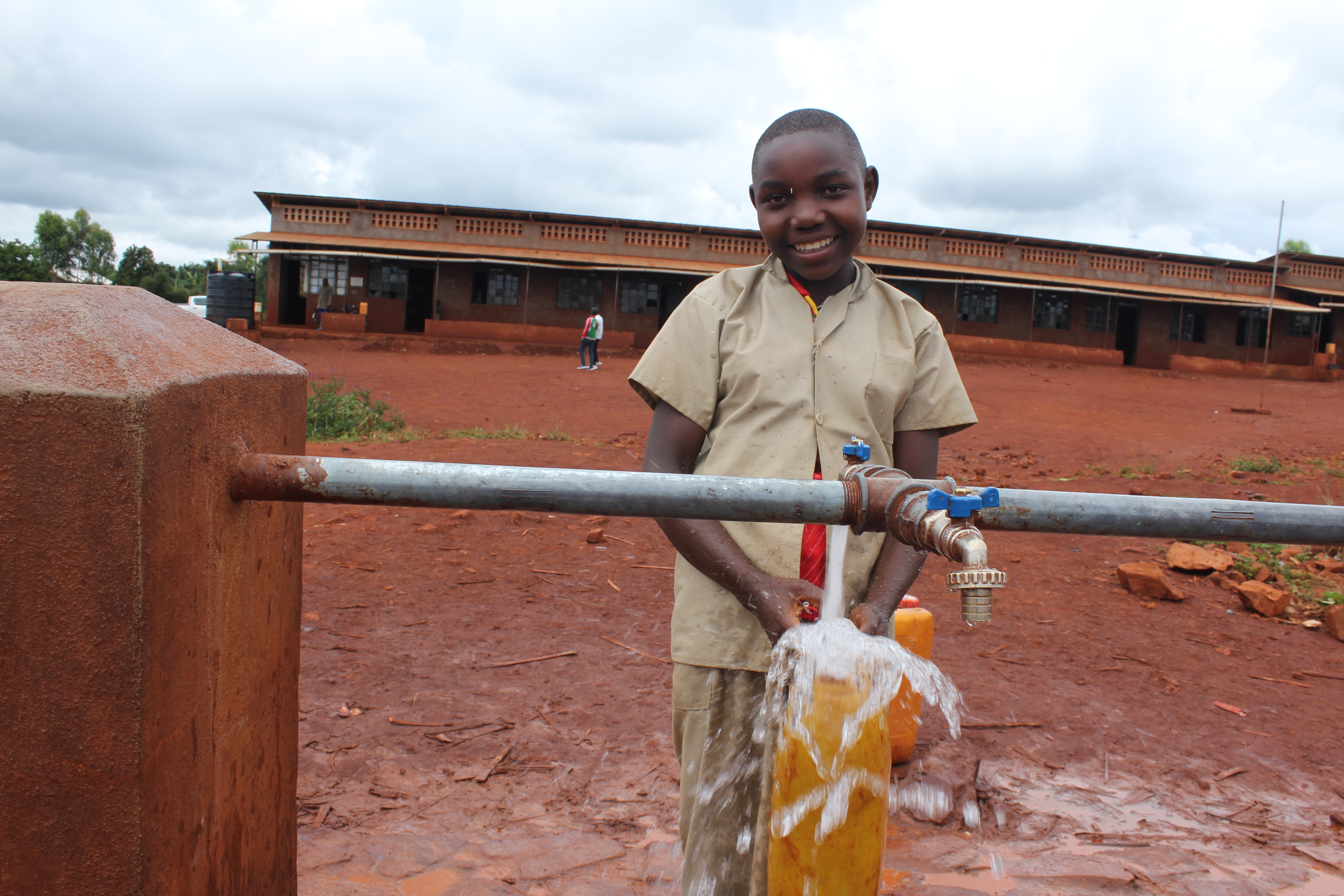 Evelyne collects clean water within her school compound; she used to make 1 km to a borehole to quench her thirst