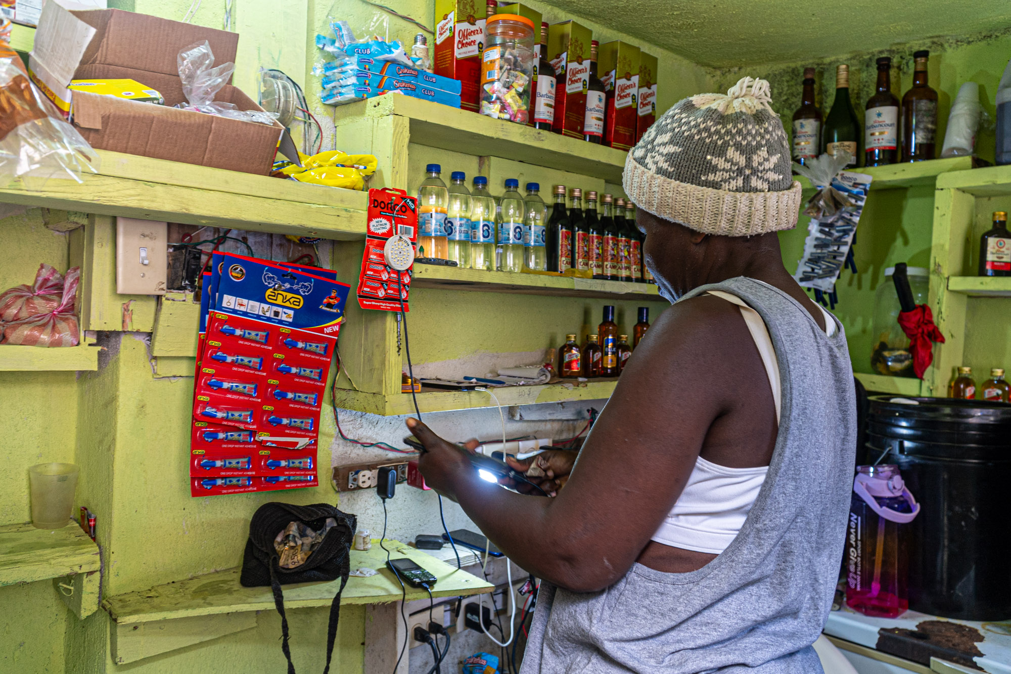 women charging a cell phone in haiti