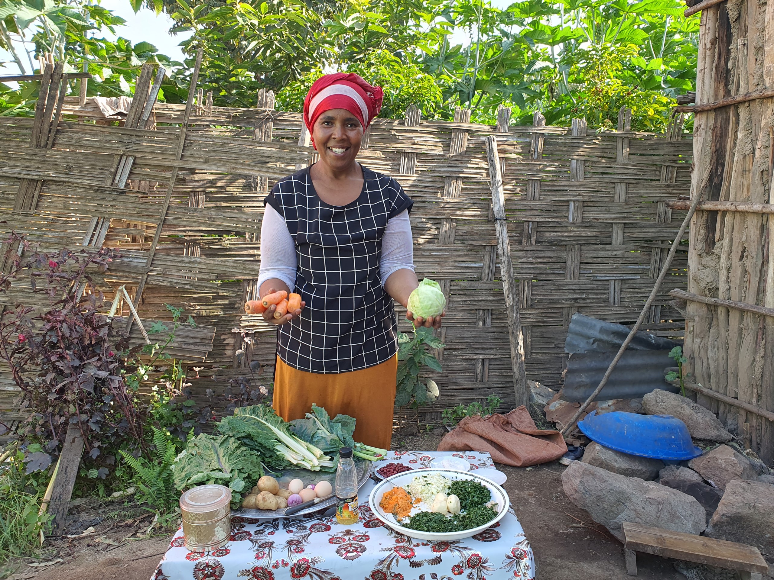 Hindiya showing the vegetables she grows in her backyard