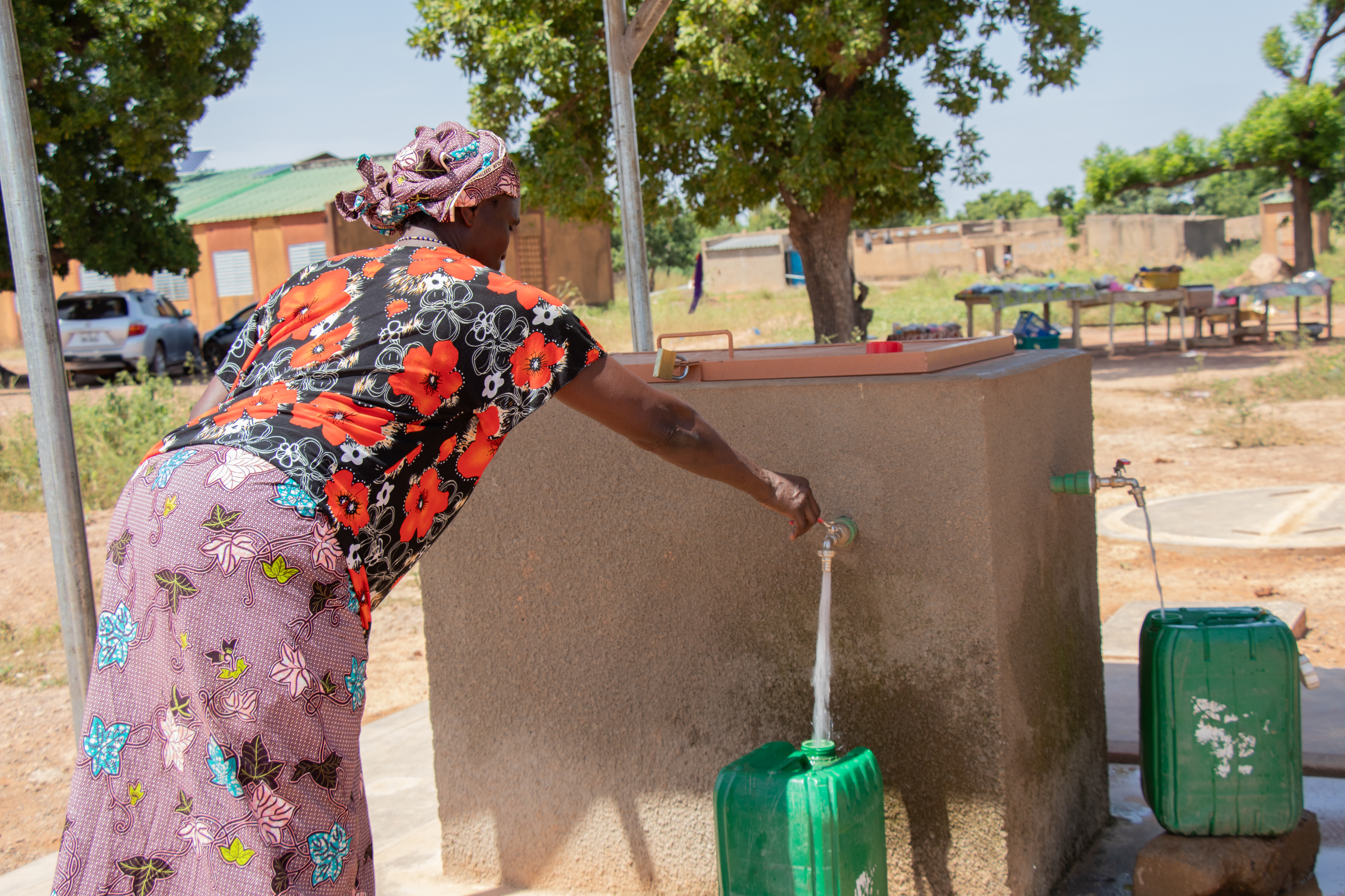 Pascaline at the hydrant to fetch water for her needs 