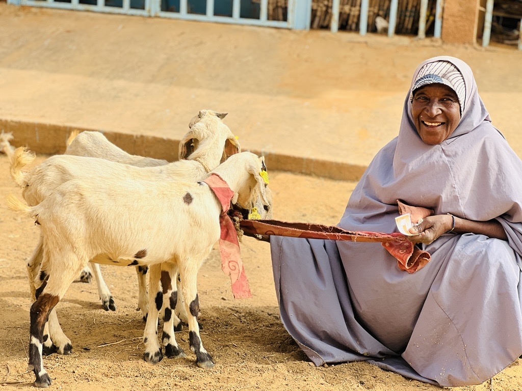 Smiling woman with a goat.