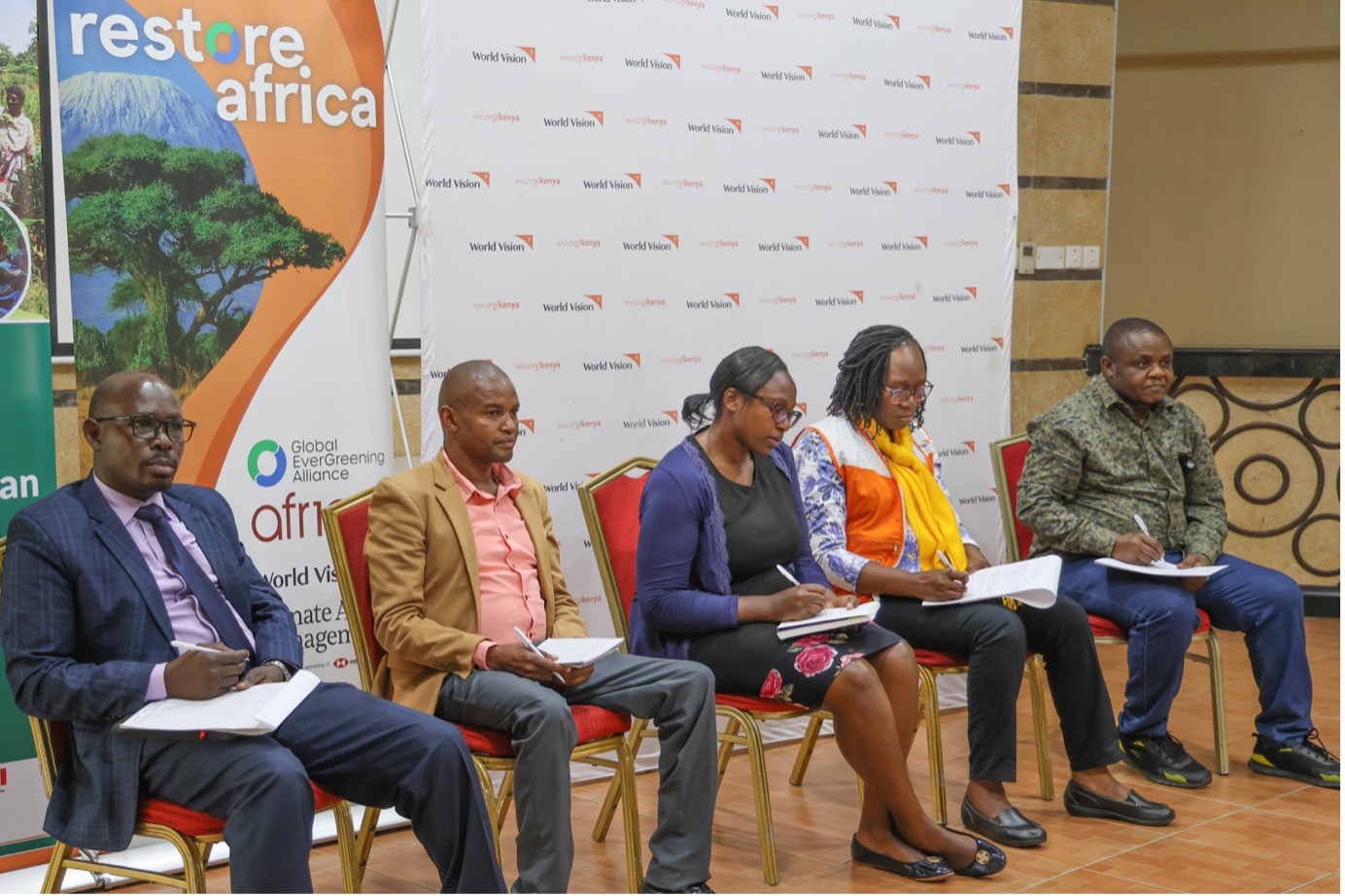 Panelists from Restore Africa consortium partner organisations addressing feedback from stakeholders. © World Vision Photo/Felix Pilipili