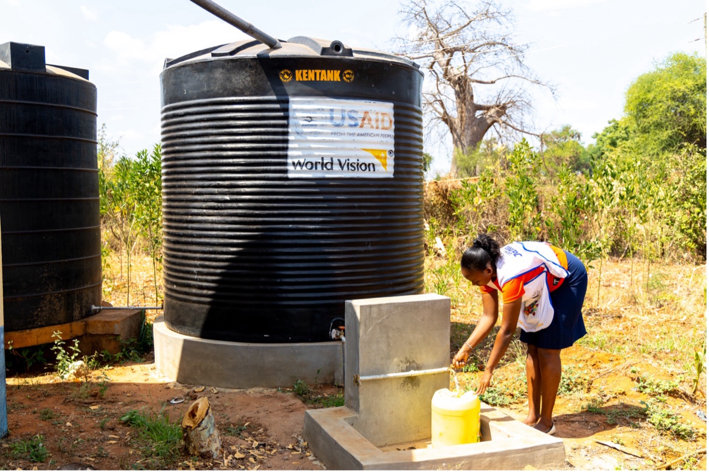 A nurse at Kasaala Health Centre is fetching water from a 10,000-litre tank installed by World Vision Kenya through support from USAID-Bureau for Humanitarian Affairs. Photo: Jared Ontobo/World Vision Kenya 2024.