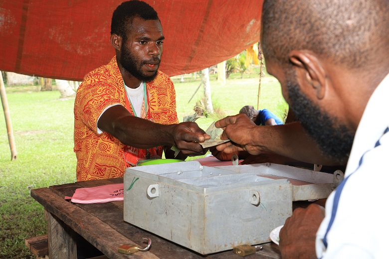 An example of a Savings Group in Sotebu village, Middle Ramu District, Madang Province – Papua New Guinea. Raymond and his family are also part of a Savings Group such as these and they have used it to save money for their children’s school fees. Picture: Steven Doe.