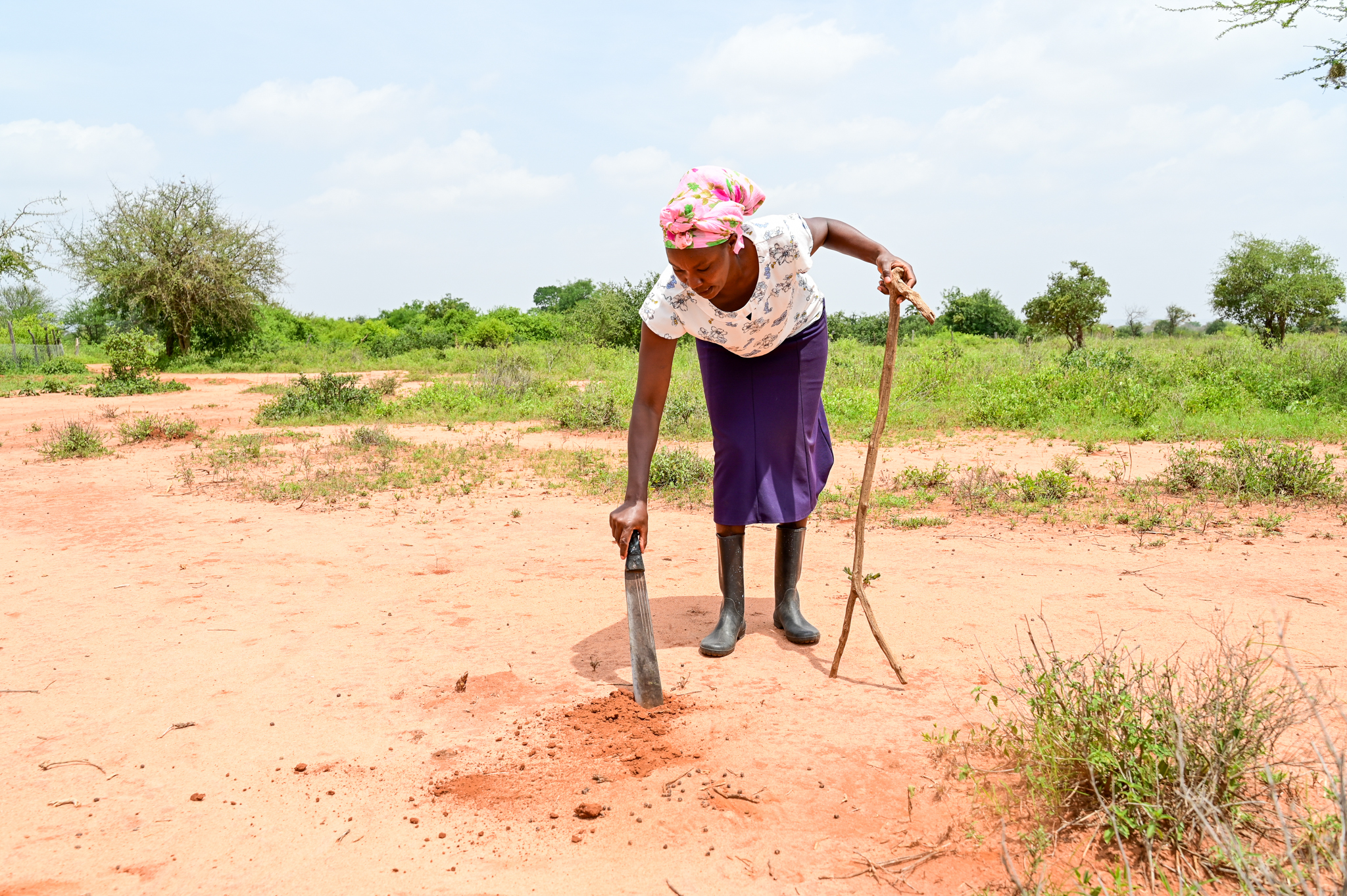 Mercy demonstrates how bare her farm once  looked like. ©World Vision Photo/ Hellen Owuor