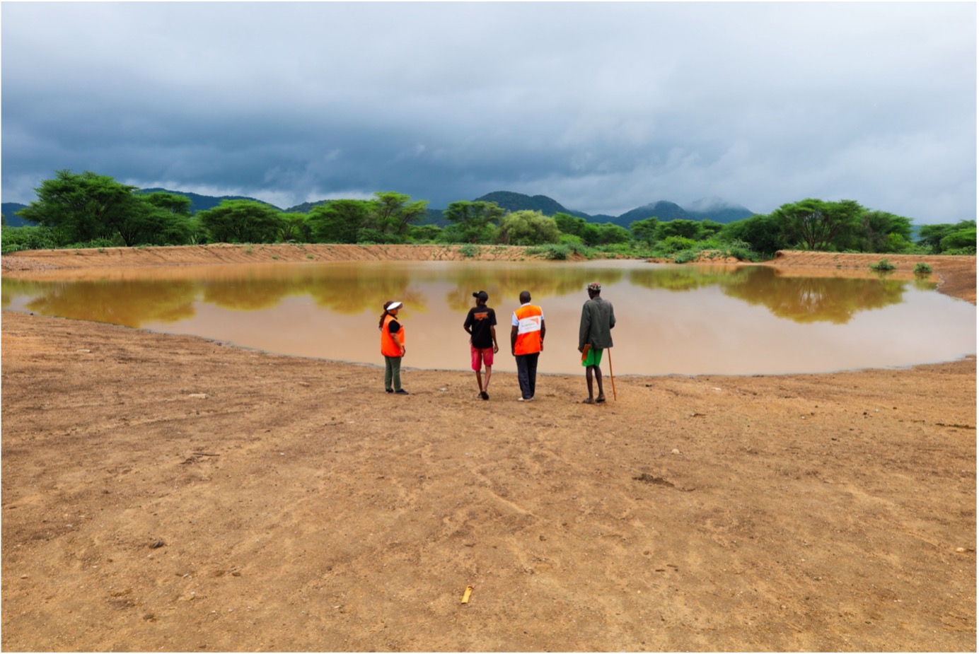 An aerial view of the Nalapatui Water Pan in Turkana County, Kenya, recently rehabilitated to provide a vital water source for the community amidst years of severe drought. The once-parched landscape now surrounds the water pan, offering renewed hope to the resilient people of Nalapatui village. ©World Vision Photo/Felix Pilipili