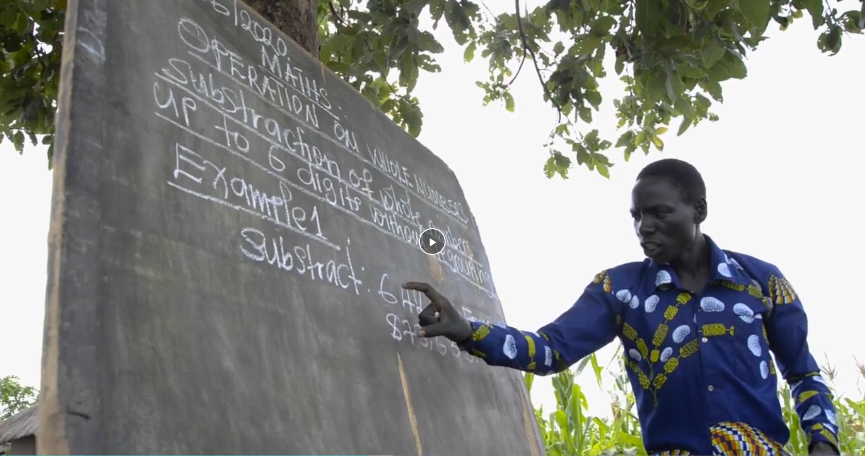 Santos teaches math to students in the open in Uganda