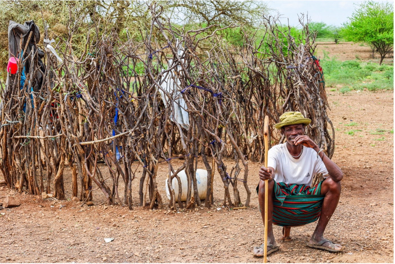 Epua Lokele, seated on an ‘Ekicholong,’ a traditional Turkana stool carved from wood and reserved for men. Epua lost his livestock to drought and has embraced sorghum farming for livelihood. © World Vision Photo/Felix Pilipili