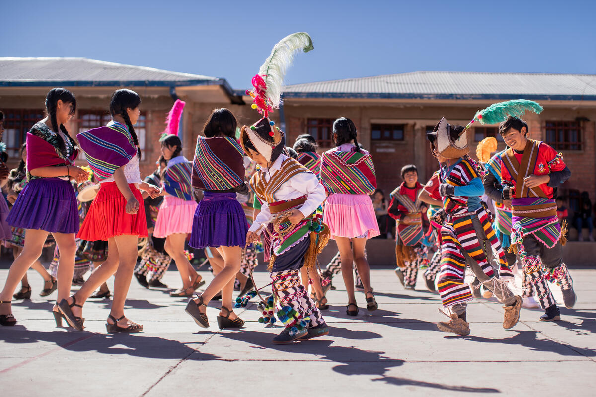 Children dancing while wearing traditional Bolivian clothing