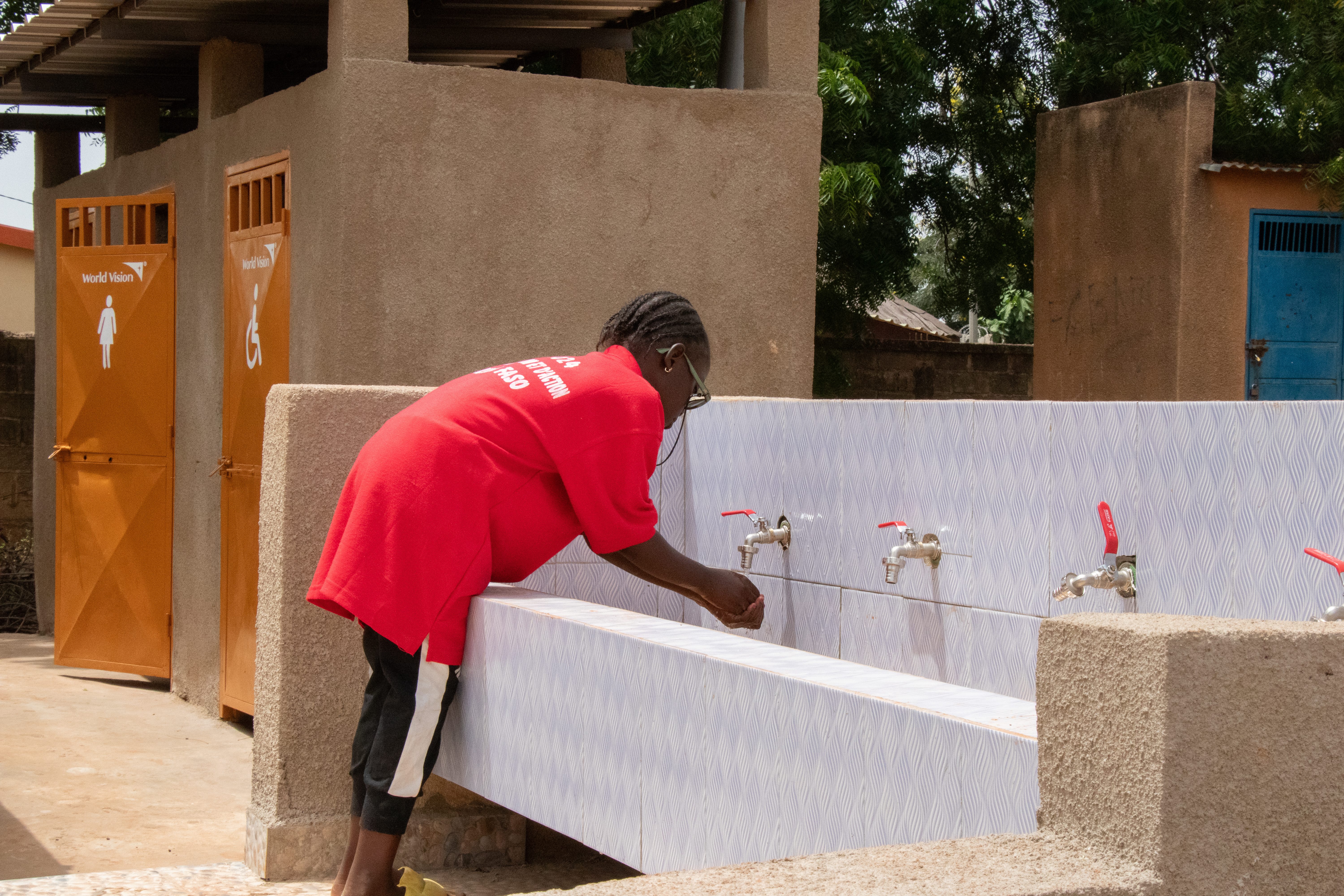 A child using the WASH infrastructures implemented by World Vision