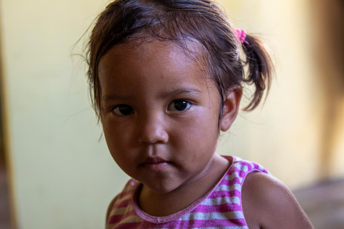 A 2-year-old looks into the camera