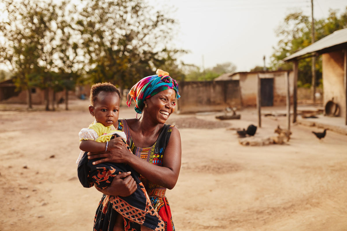 A woman carrying her child