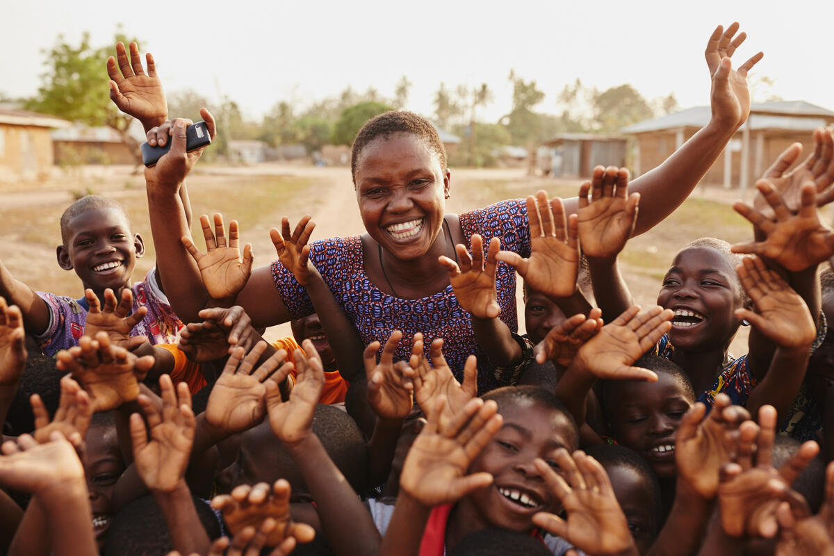 Group of children waving at the camera