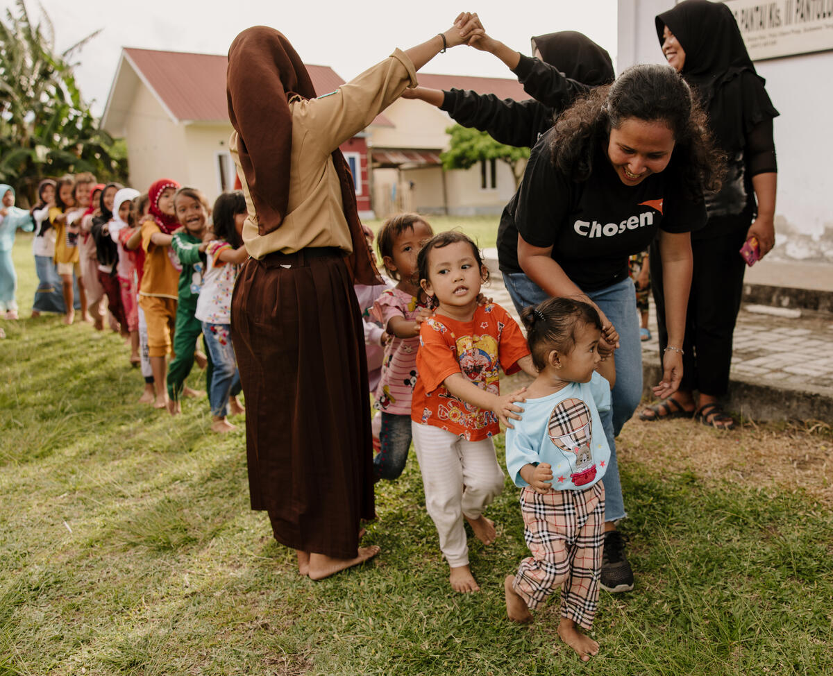 Children playing with their teachers