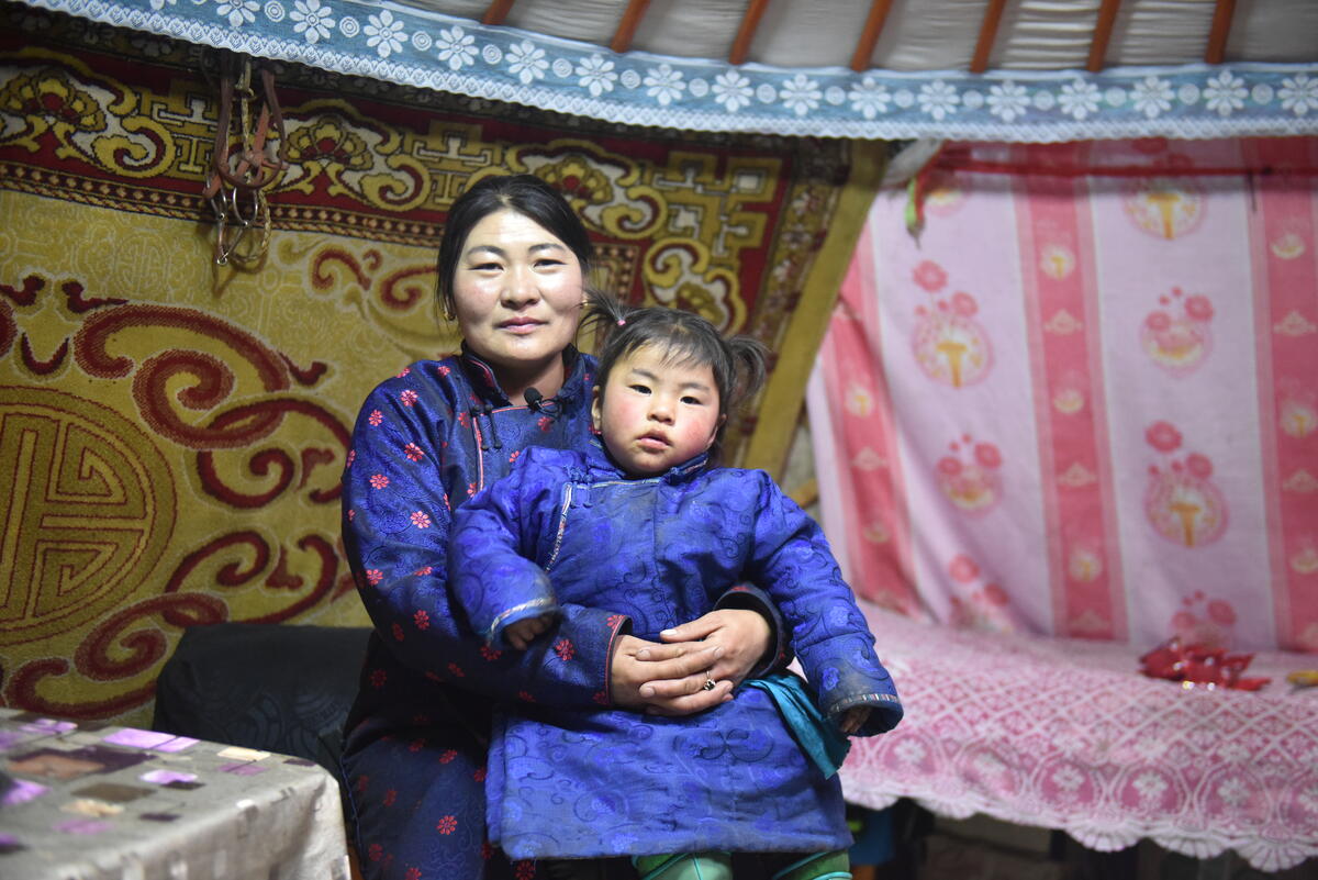 Mongolia woman holding child