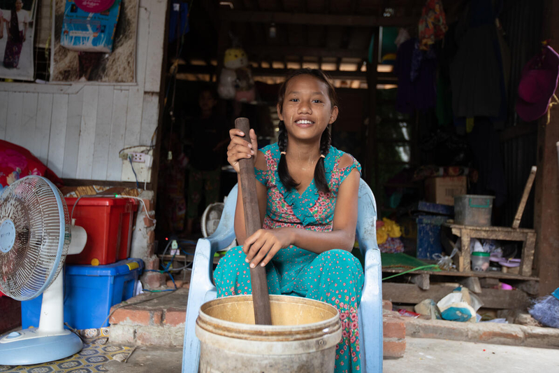 Ei, from Myanmar, doing household chores at home