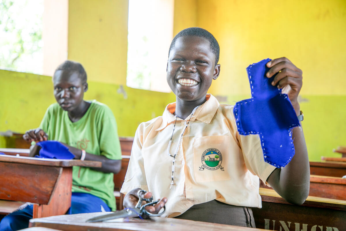 A girl making a sanitary towel from material