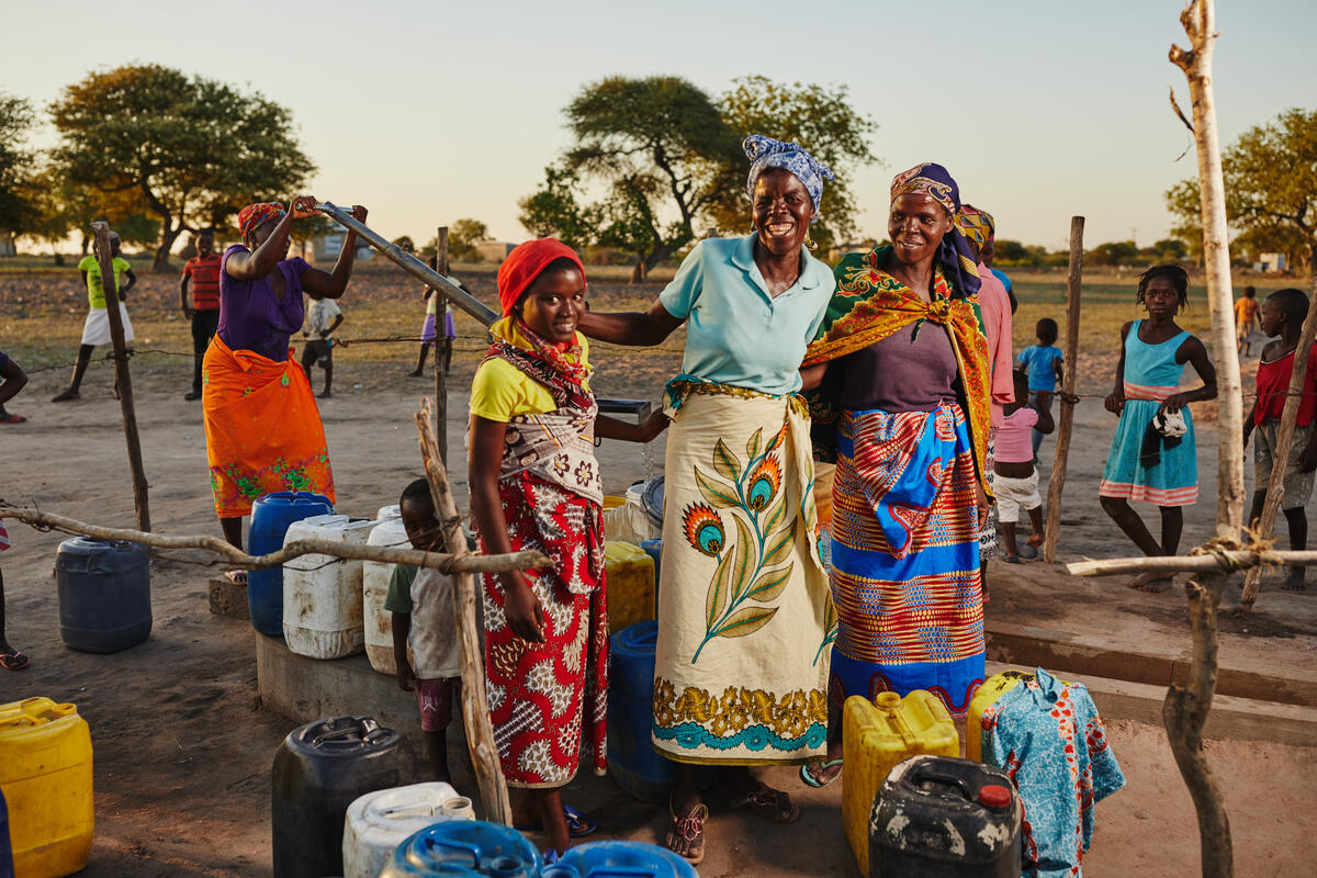 Women standing next to a well in Mozambique