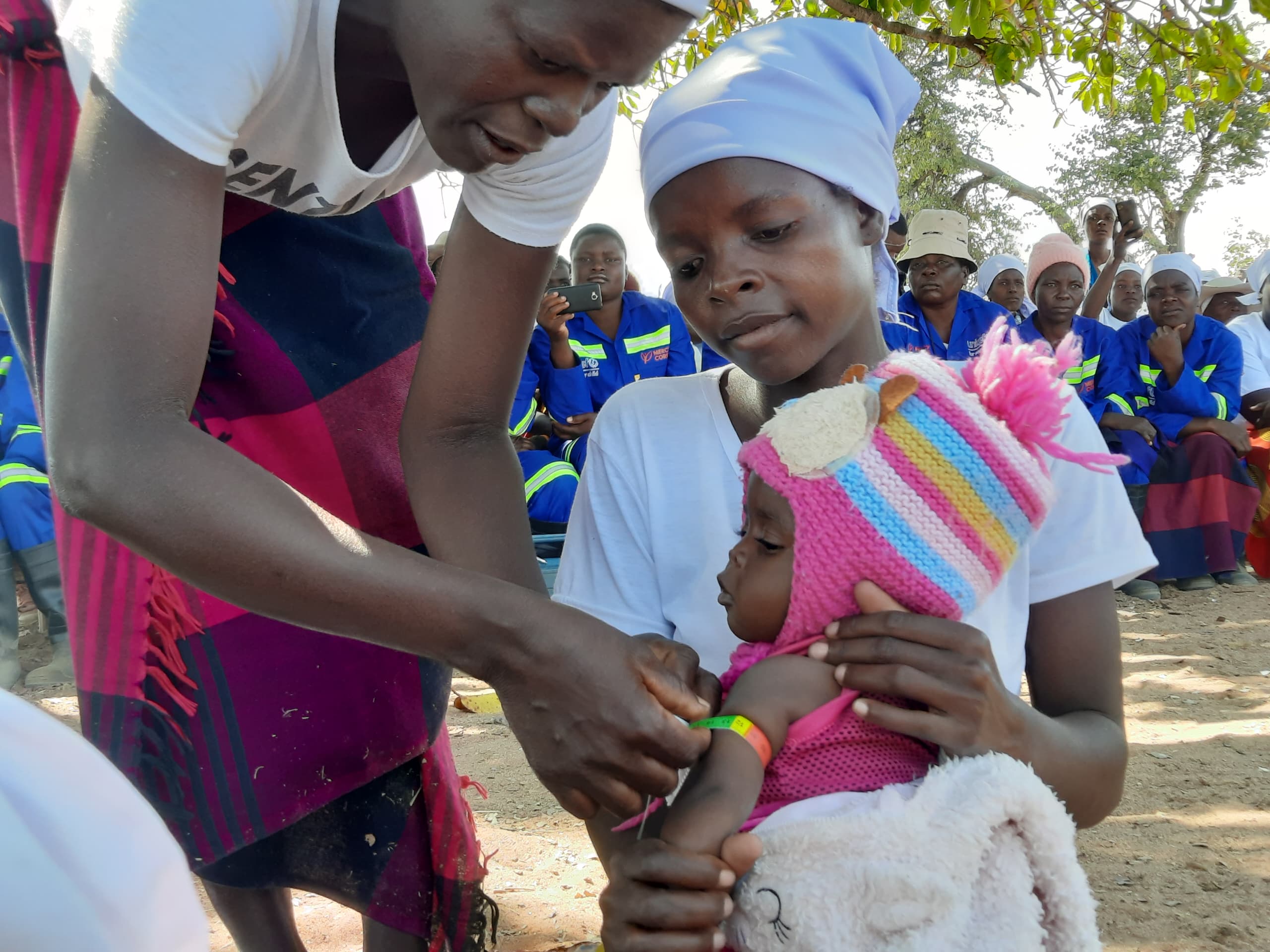 Jane Sithole, Community Health Worker screening a child her from her village